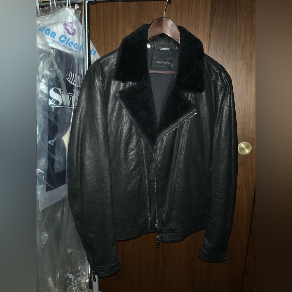 Men’s black leather jacket with fur collar.